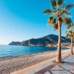 View to beautiful Albir town with main boulevard promenade, seaside beach and Mediterranean sea. Albir is small resort city between Altea and Benidorm, Alicante province, Spain