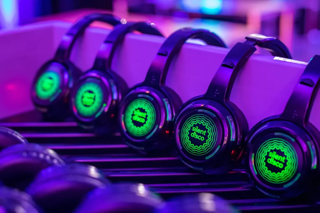 Green Silent Disco Headphones aligned at an event