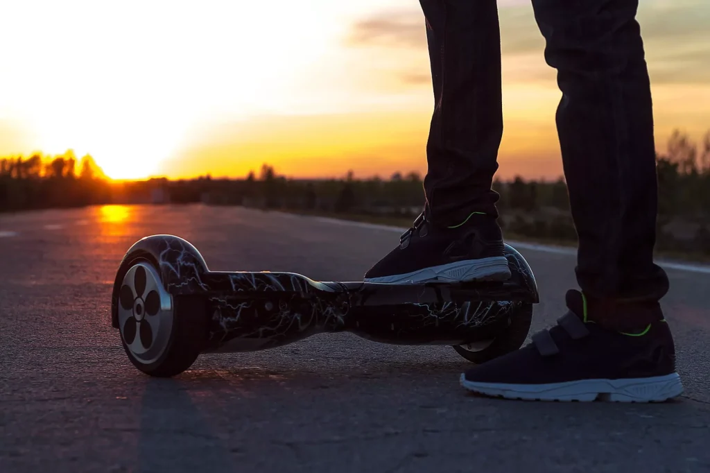 The guy put his right foot on the black gyroscope to start moving towards the setting sun.