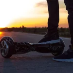 The guy put his right foot on the black gyroscope to start moving towards the setting sun.
