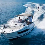 Speedboat with wakeboard rider on open sea
